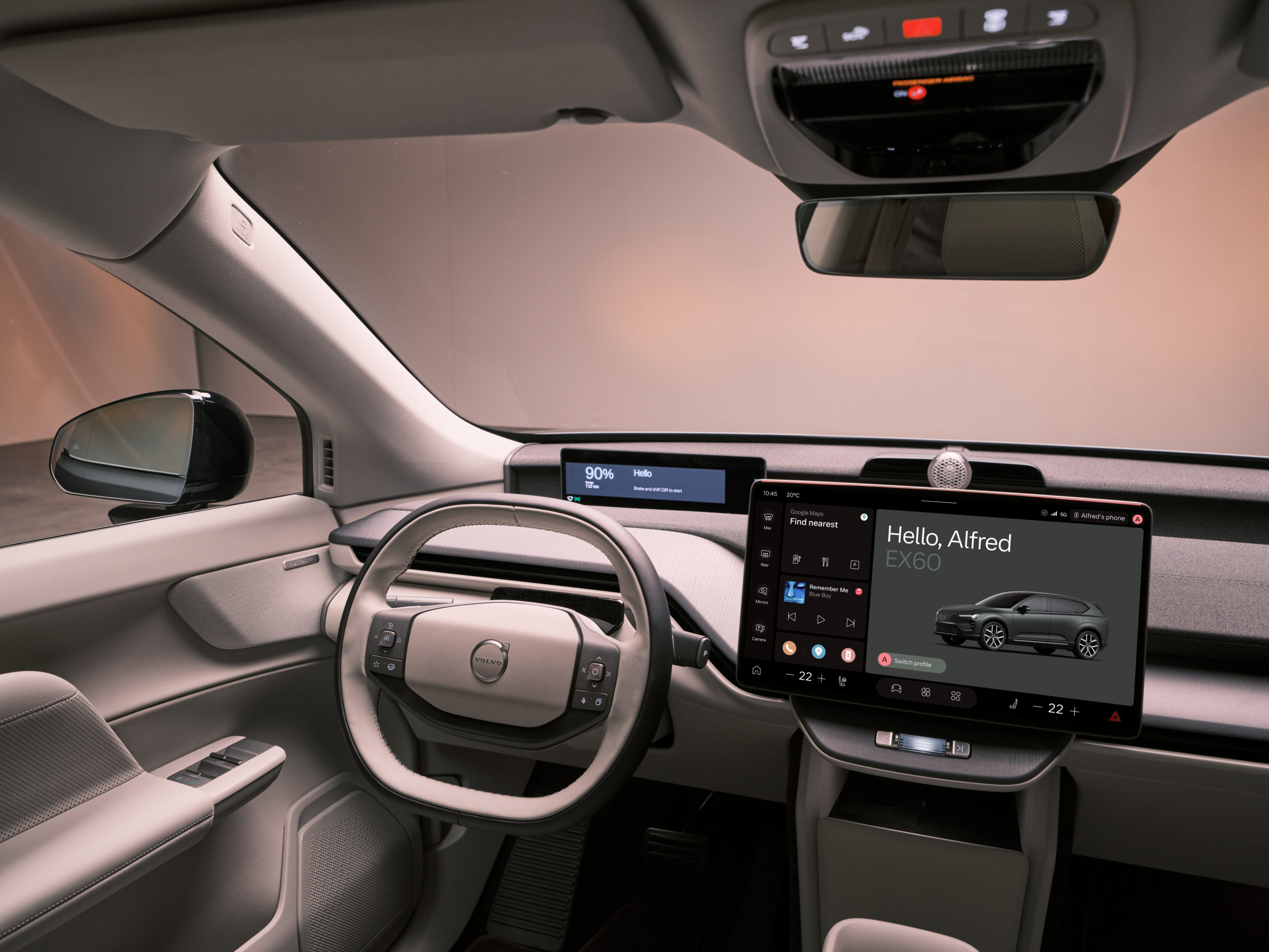 Szeroki widok na deskę rozdzielczą Volvo EX60 z dużym ekranem centralnym wyświetlającym interfejs systemu.