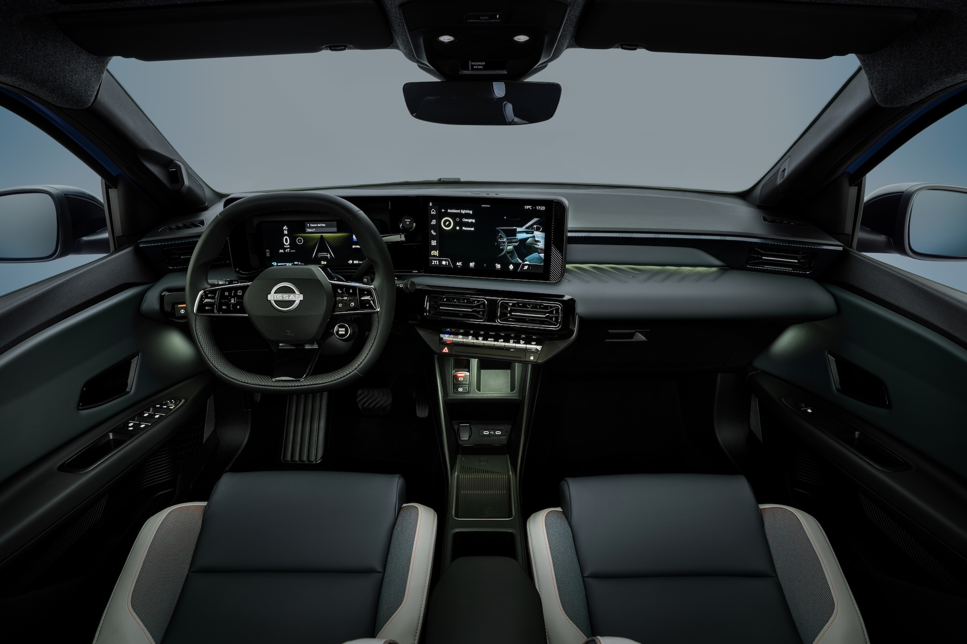 Nissan Micra dashboard and cockpit from driver's POV revealing green ambient lighting by side doors, on dashboard and below air conditioning buttons