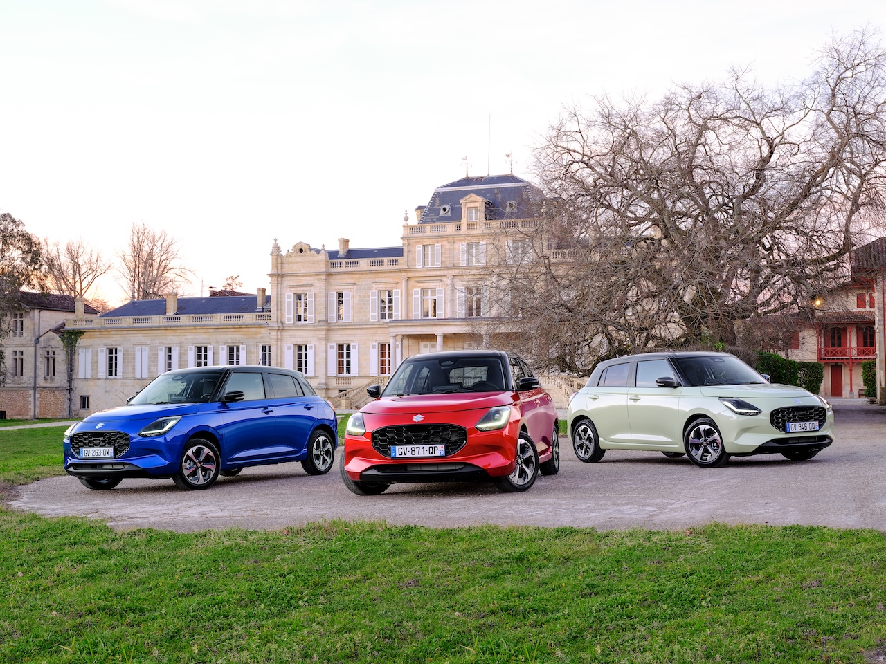 Trzy Suzuki Swift na tle eleganckiej rezydencji